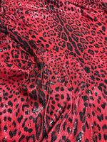 Red leopard print sequin fabric with 2-way stretch, perfect for glamorous evening wear and sewing projects