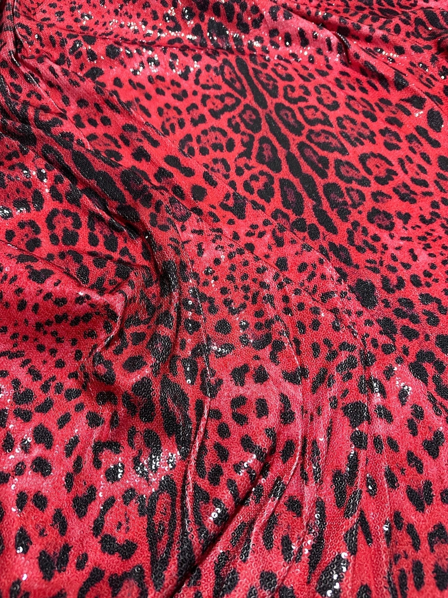 Red leopard print sequin fabric with 2-way stretch, perfect for glamorous evening wear and sewing projects