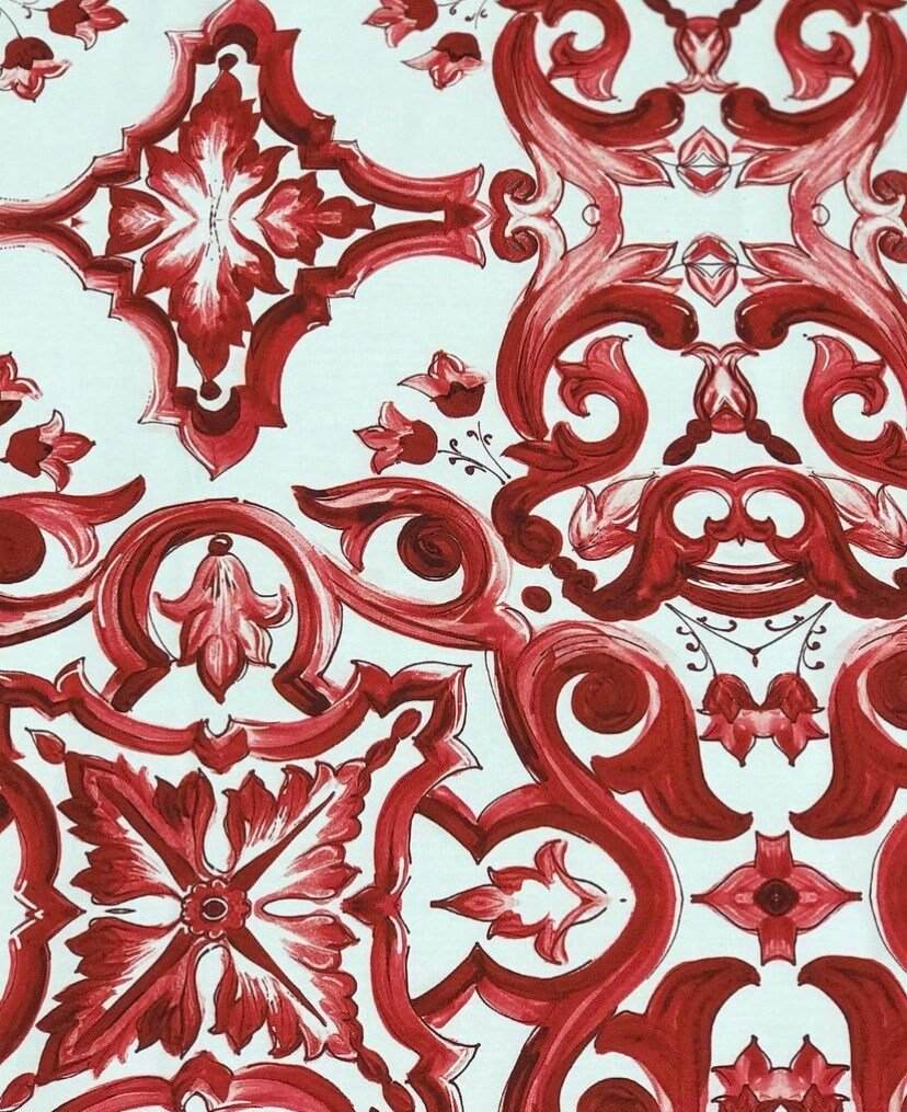 Red Majolica pattern fabric with intricate floral and ornamental designs in rich red tones on a white background