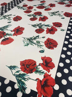Red poppy floral fabric with black and white polka dot border