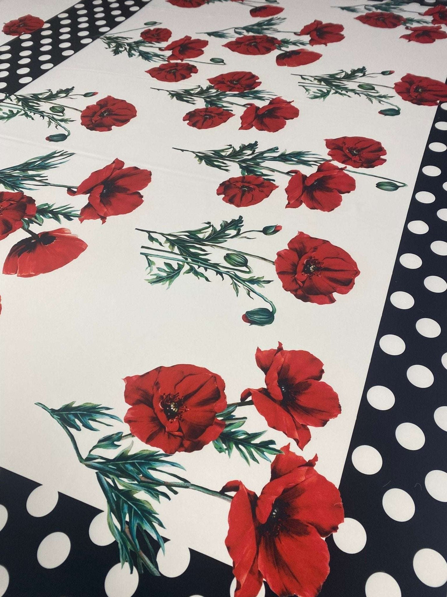 Red poppy floral fabric with black and white polka dot border