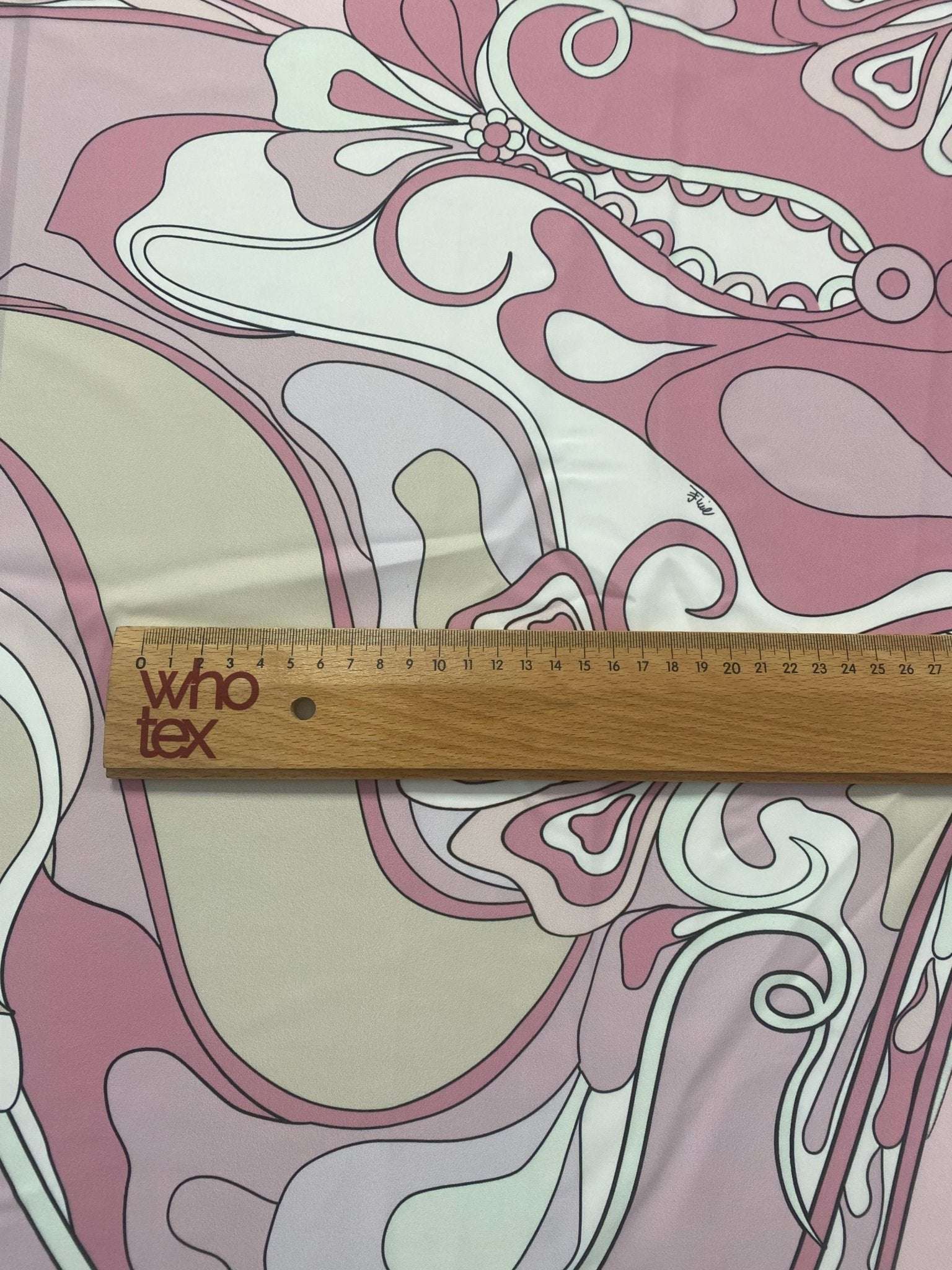Retro pink abstract floral fabric with ruler showing scale and 150cm width