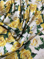 Yellow floral rose pattern fabric with green leaves on white background, 150cm wide textile for sewing and crafting projects
