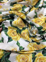 Yellow floral rose pattern fabric with green leaves on white background for sewing and crafting projects
