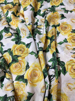 Yellow floral rose pattern fabric with green leaves on white background, 150cm wide textile for sewing and crafting projects