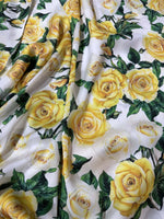 Yellow floral rose pattern fabric with green leaves on white background for sewing and crafting projects