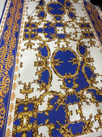 Royal blue baroque pattern fabric with ornate gold designs on a white background for upholstery and drapery