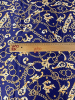 Royal blue fabric with gold chains and baroque scrolls pattern and ruler for scale