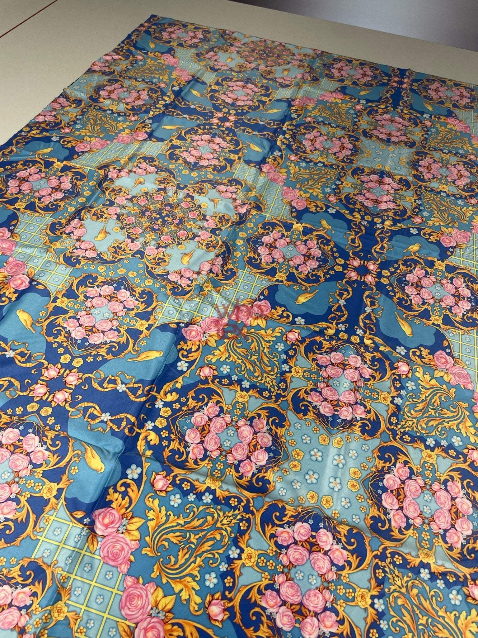 Royal blue ornate fabric with roses, birds, and gold scroll patterns