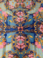 Royal blue ornate fabric with pink roses, yellow birds, and gold scroll patterns