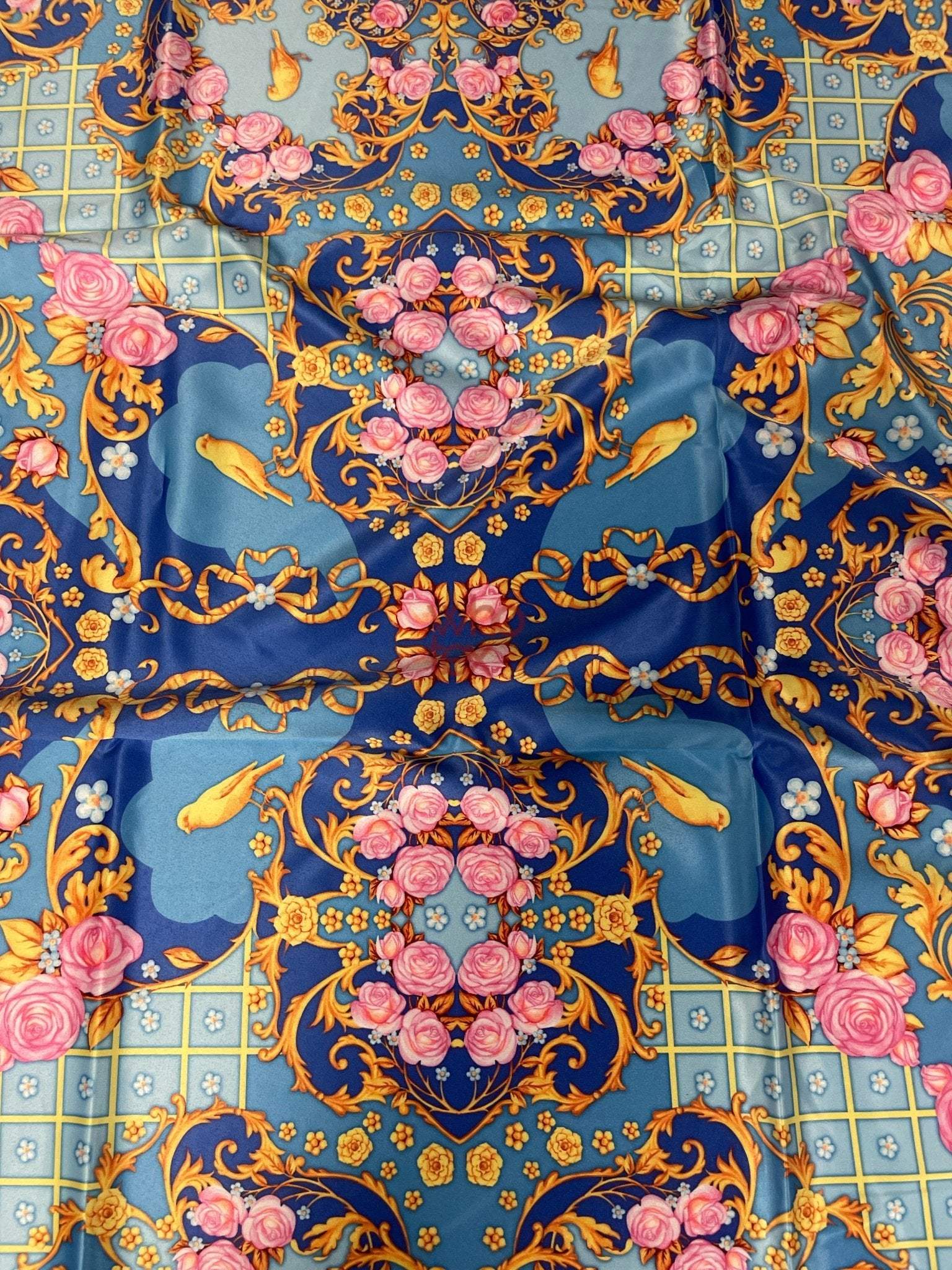 Royal blue ornate fabric with pink roses, yellow birds, and gold scroll patterns