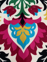 Close-up of Santa Maria Outdoor Upholstery Fabric with vibrant floral pattern in pink, blue, yellow, green, and black on white background