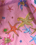 Sea shell pattern sugar chiffon fabric with colorful starfish and sea motifs on pink background