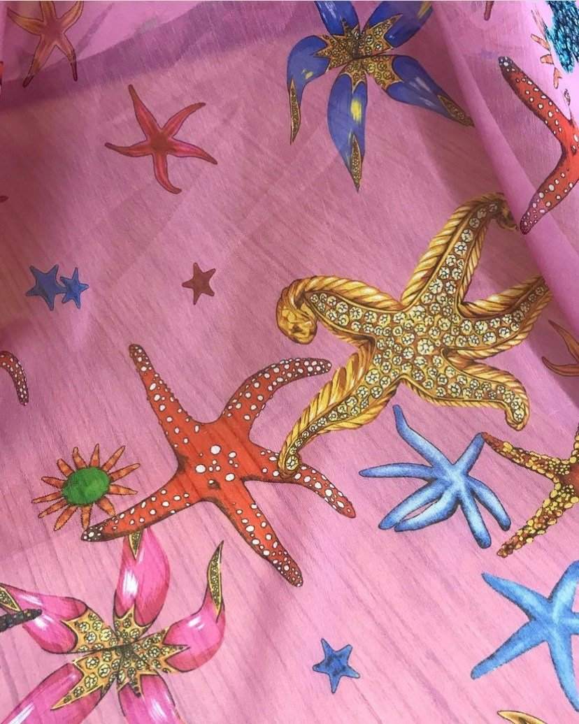 Sea shell pattern sugar chiffon fabric with colorful starfish and sea motifs on pink background