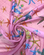 Pink sugar chiffon fabric with colorful sea shell pattern and starfish design