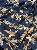 Black luxury fabric with intricate gold sea shell pattern on a deep black background