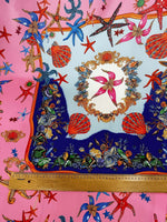 Coastal sea shell fabric with colorful starfish, shells, and marine patterns on a pink background with a measuring ruler