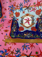 Coastal sea shell fabric with colorful starfish and shell patterns on pink and blue background