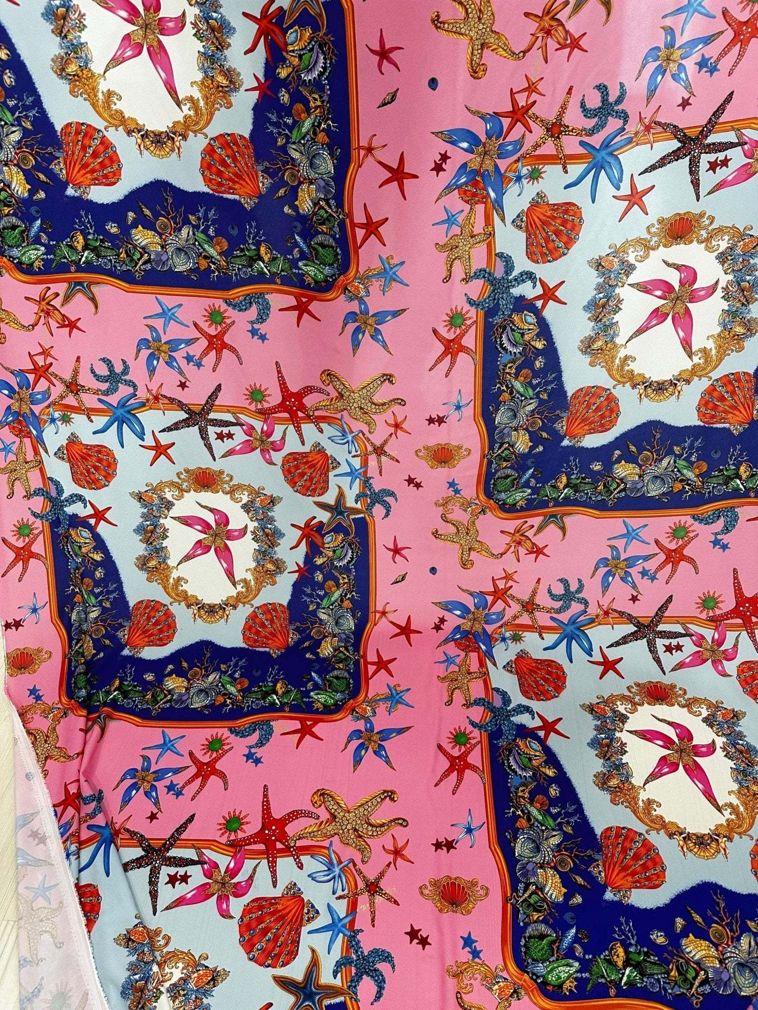 Coastal Sea Shell Fabric with pink background featuring starfish, seashells, and marine-themed decorative patterns for sewing and crafts