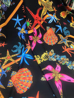 Black Pink Starfish and sea shell pattern fabric on black background for crafting and apparel