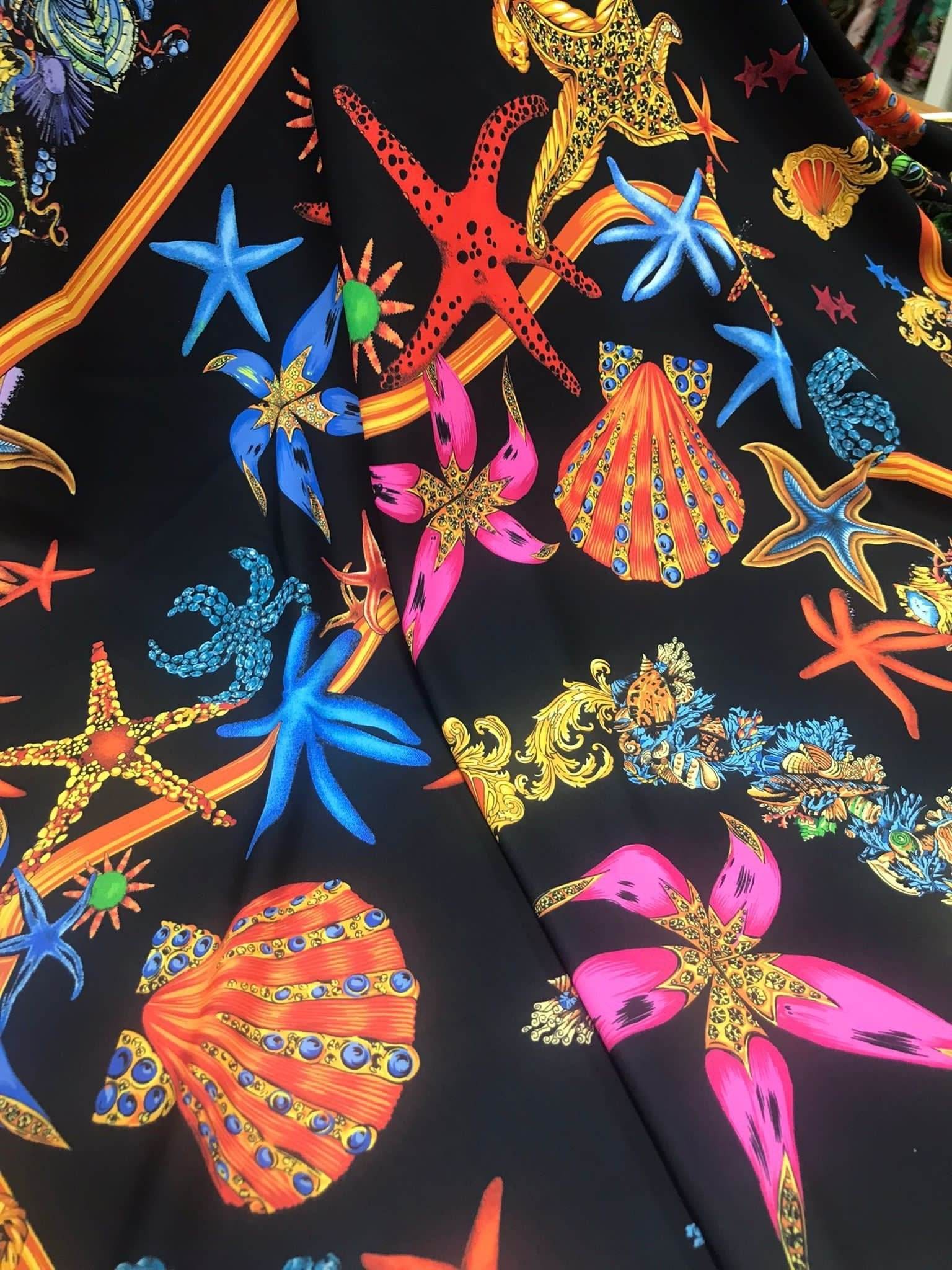 Black Pink Starfish and sea shell pattern fabric on black background for crafting and apparel