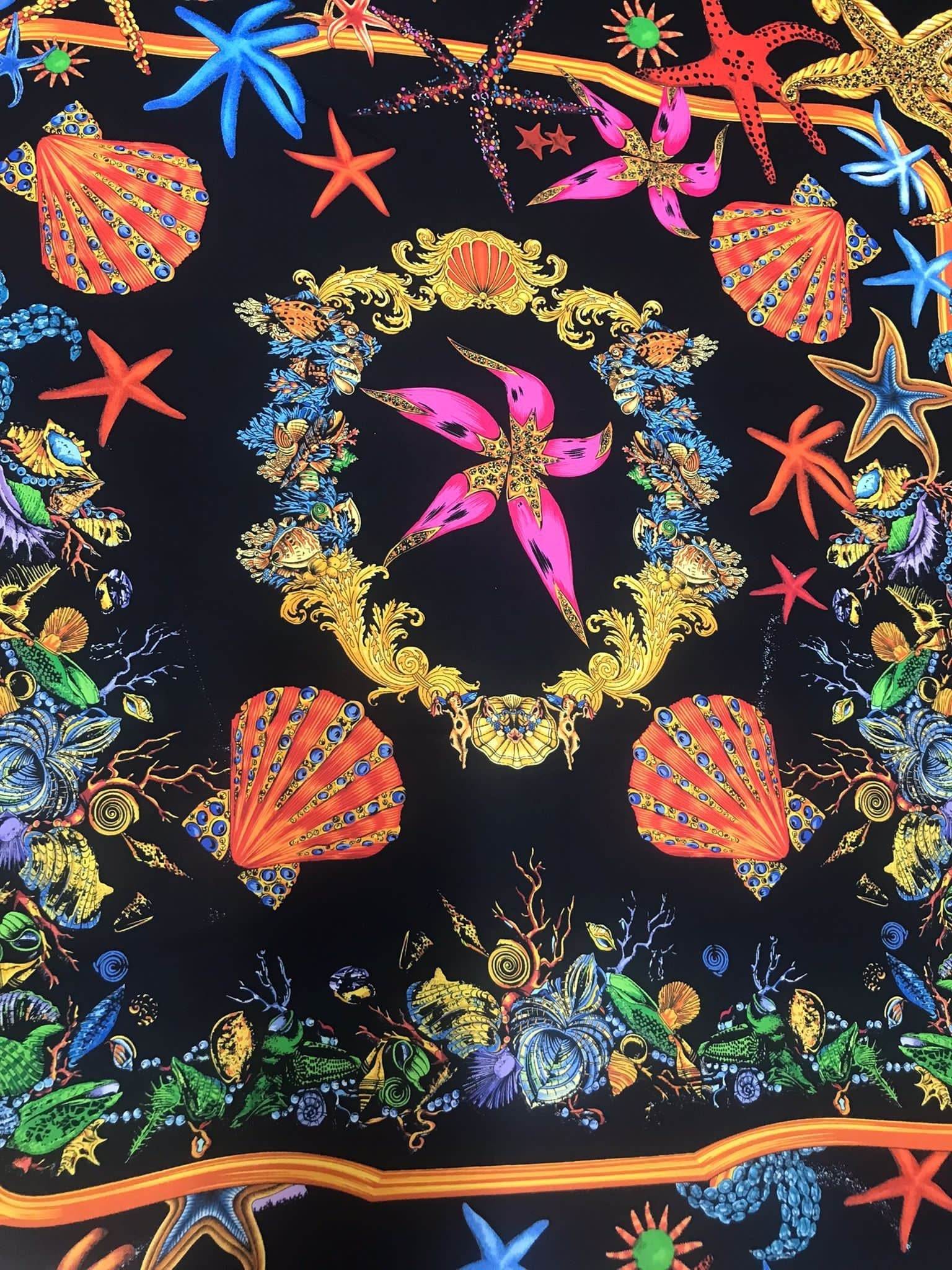 Black pink starfish and sea shell patterned fabric on black background