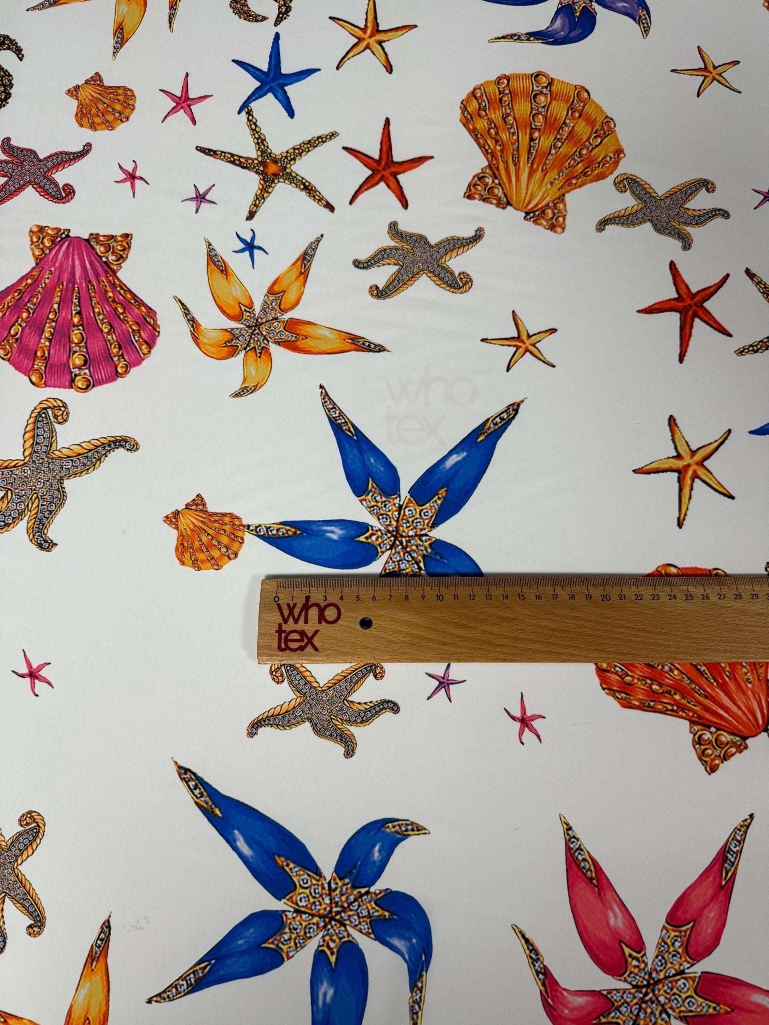 Sea Shell Fabric with colorful starfish and seashell prints on white background, fabric width 150cm.
