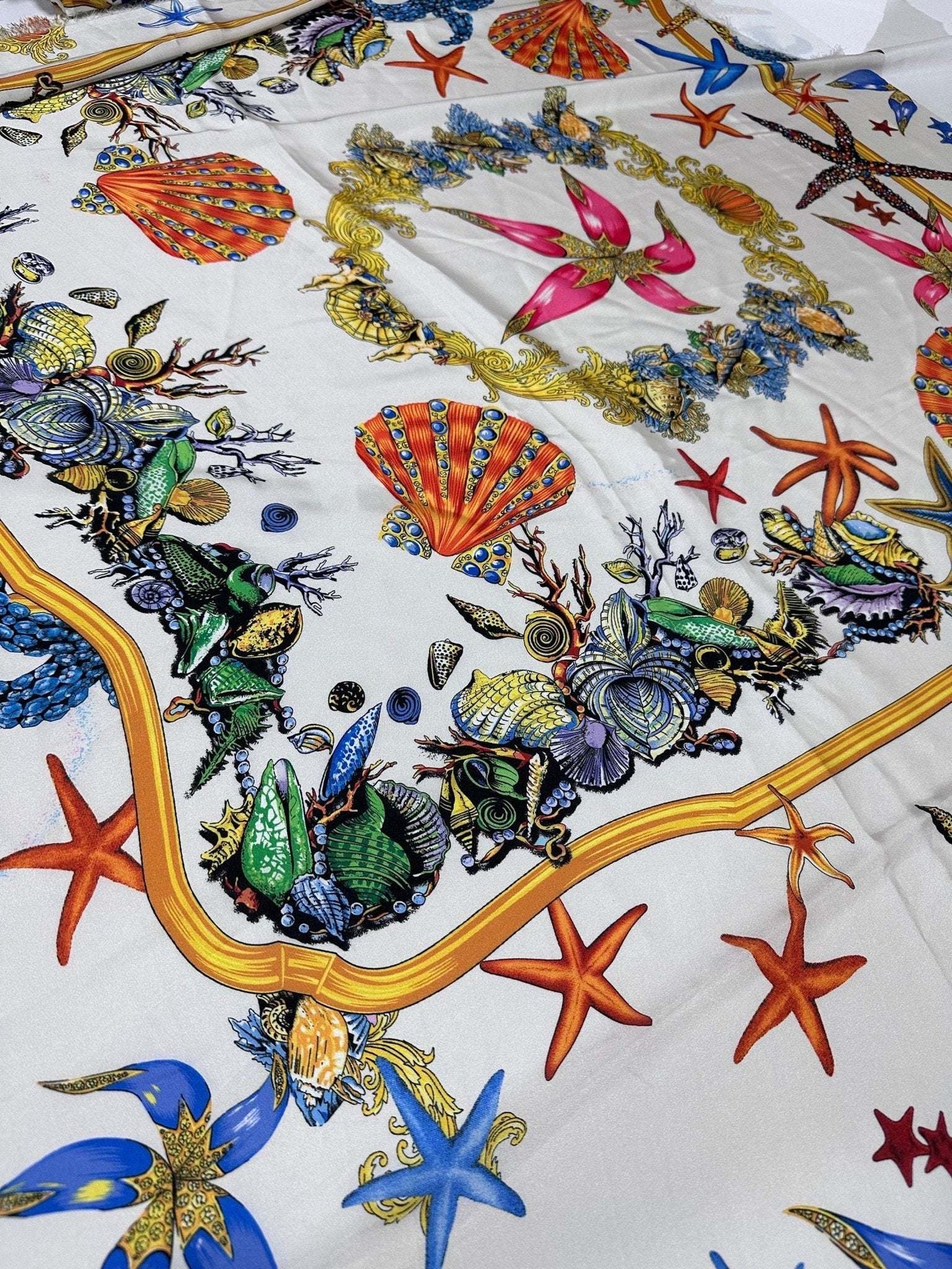 White fabric with colorful sea shell pattern and starfish design for sewing projects