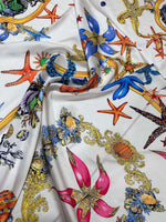 White fabric with colorful sea shell and starfish pattern for sewing projects