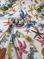 White fabric with colorful sea shell and starfish pattern for sewing projects