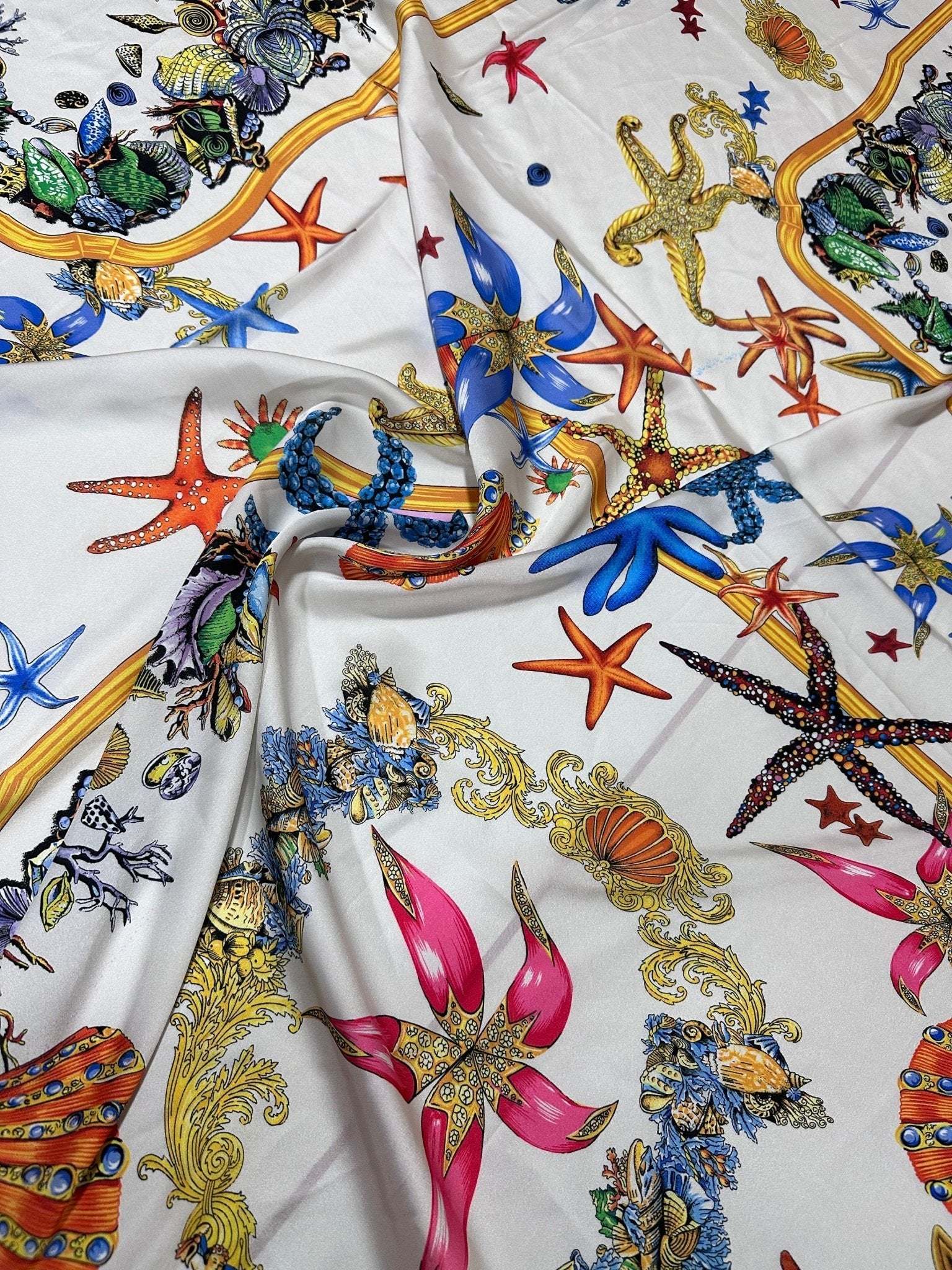 White fabric with colorful sea shell and starfish pattern for sewing projects
