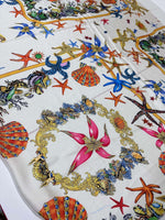 White fabric with colorful sea shell and starfish pattern for beach-themed sewing projects