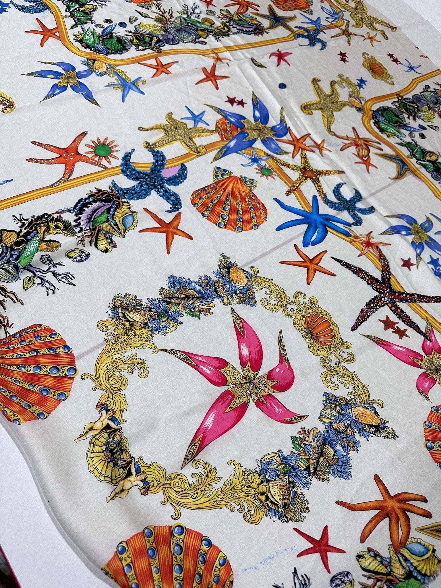 White fabric with colorful sea shell and starfish pattern for beach-themed sewing projects