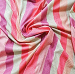 striped glitter lurex stretch fabric in pink, red, and cream with shimmering vertical stripes and 2-way stretch