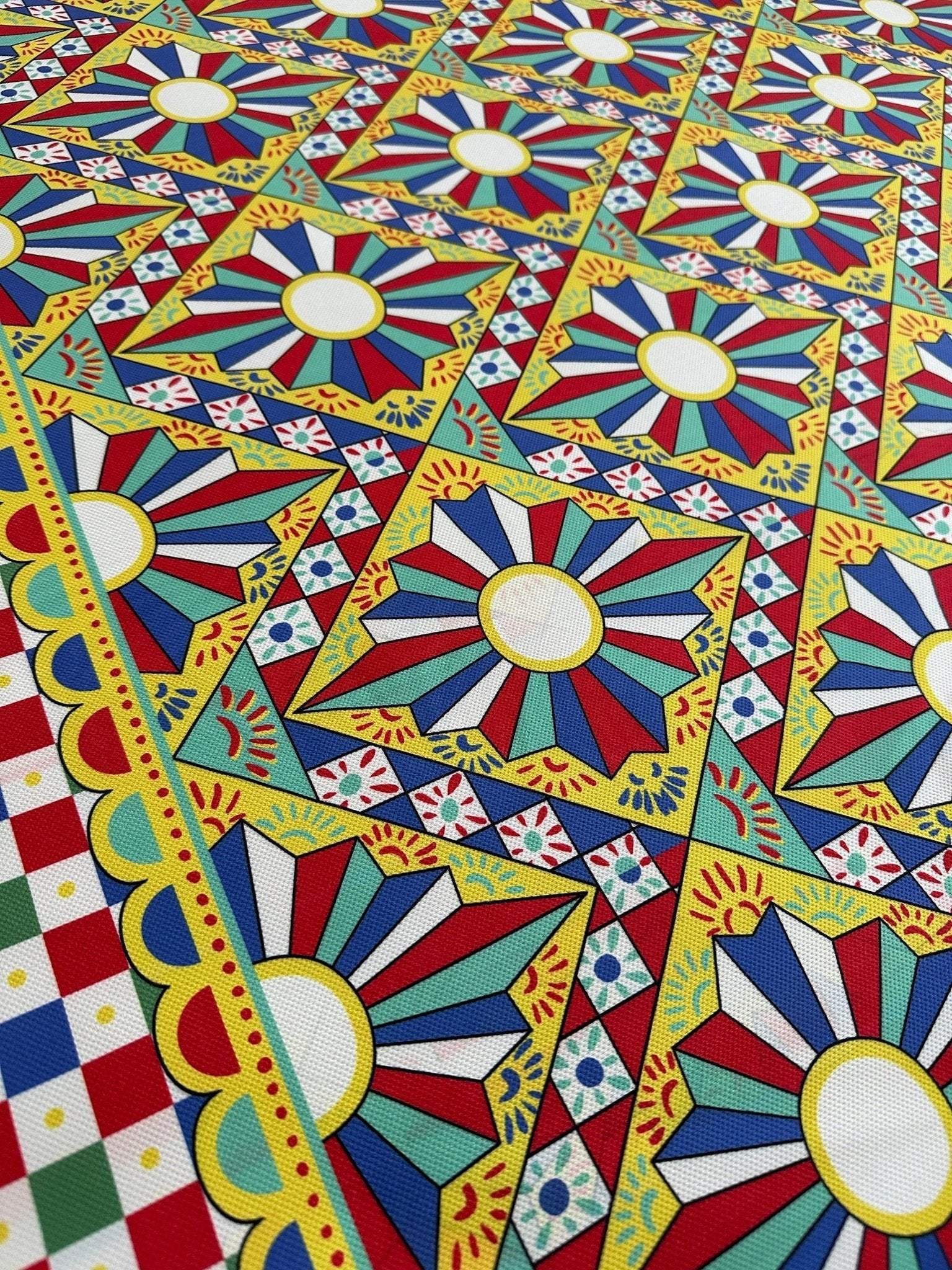 Sicilian Caretto Upholstery Fabric with colorful geometric and floral patterns in vibrant yellow, red, blue, and green colors