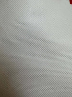 Close-up of textured white Sicilian Caretto upholstery fabric with a subtle woven pattern