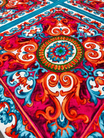 Vibrant Sicilian Caretto Pattern Fabric with intricate orange, blue, and red Italian textile design ideal for upholstery and crafts