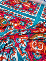 Sicilian Caretto pattern fabric with vibrant red, blue, and orange intricate designs, ideal for upholstery and crafts