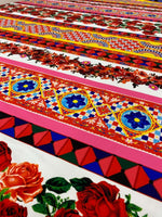 colorful Sicilian floral fabric with intricate patterns and vibrant red roses