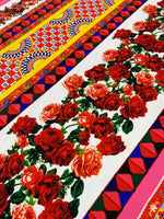 Sicilian Floral Fabric with vibrant red roses and geometric colorful patterns on a 150cm wide textile