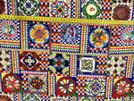 Sicilian Pattern Italian Fabric with vibrant multicolor geometric and floral designs, featuring traditional motifs and a measuring tape showing fabric width.