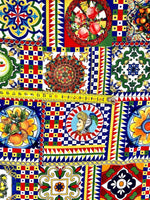 colorful Sicilian pattern Italian fabric with intricate geometric and floral designs in vibrant red, blue, yellow, and green colors, featuring traditional Sicilian motifs and a measuring tape across the fabric