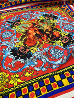 Vibrant Sicilian pattern fabric in red, blue, and yellow with intricate floral and baroque designs ideal for home decor and crafts