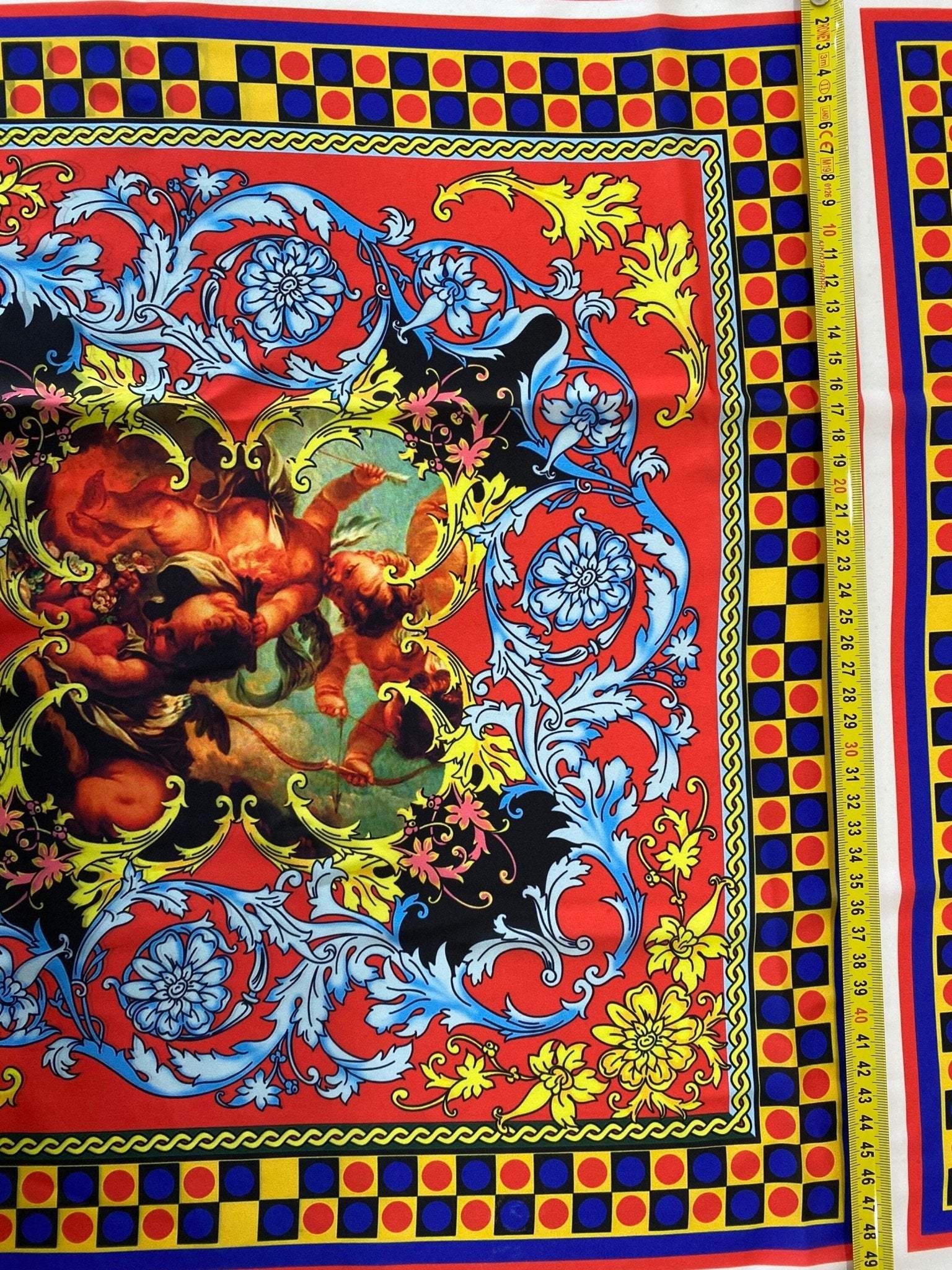 Vibrant Sicilian pattern fabric in red and blue with intricate floral and classical motifs, suitable for upholstery and home decor projects.