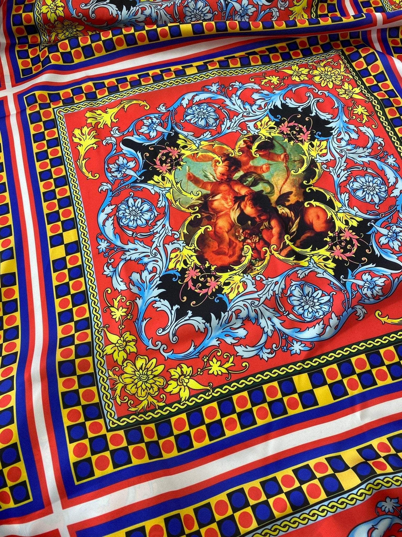Vibrant red and blue Sicilian pattern fabric with intricate floral and cherub design, perfect for upholstery and decor projects