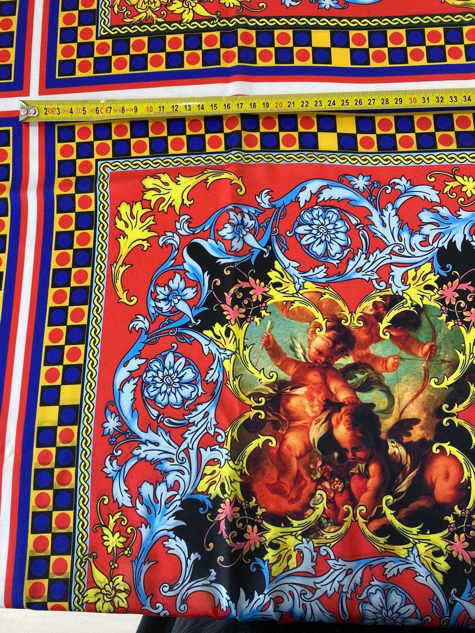 vibrant Sicilian pattern fabric in red and blue with intricate baroque design and cherub artwork for upholstery and decor, 150cm wide