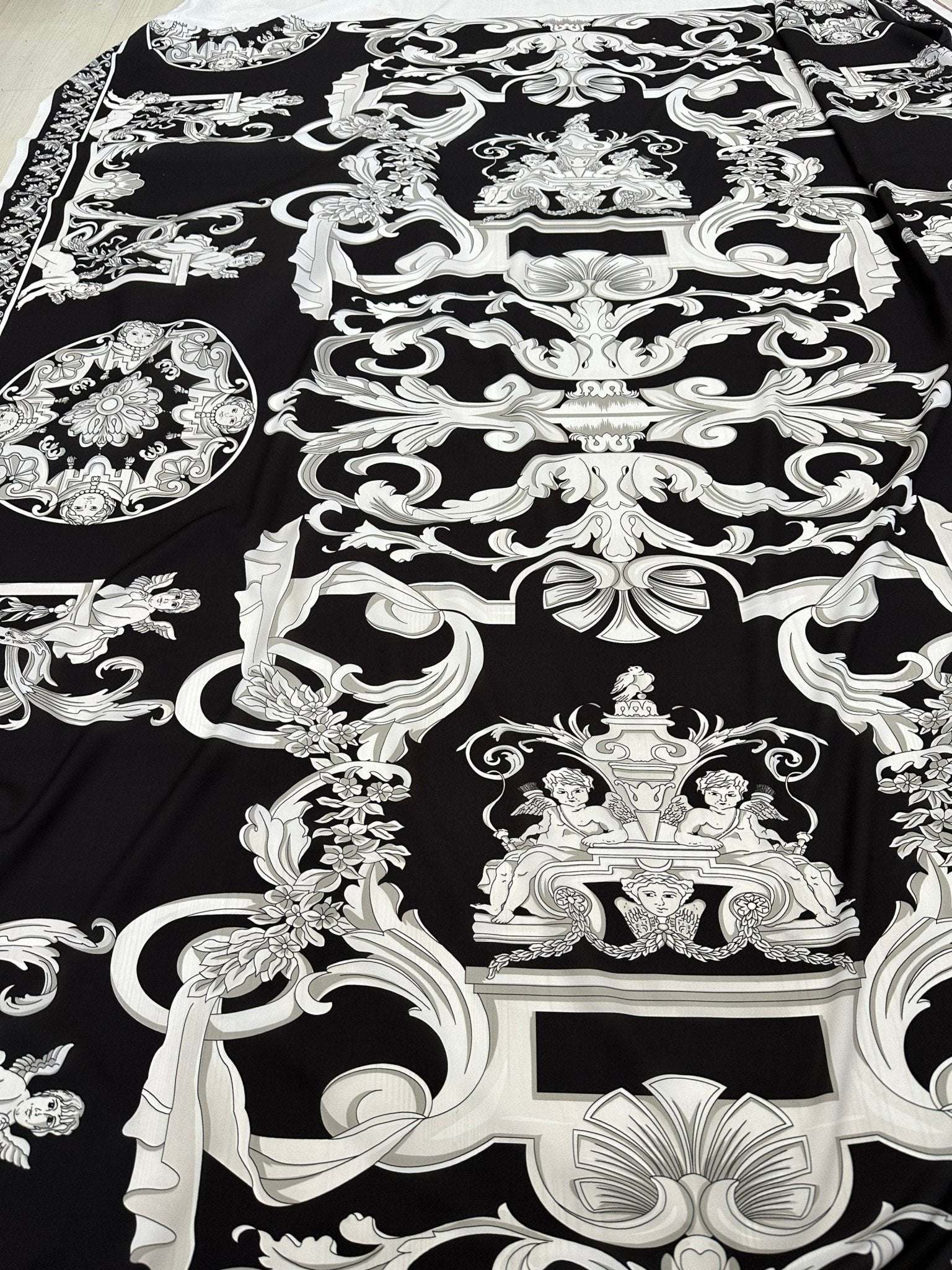 Black fabric with intricate silver baroque pattern and ornate design details