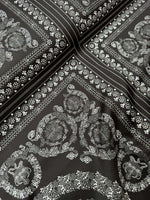 Baroque silver upholstery fabric with intricate floral and ornamental patterns on dark background