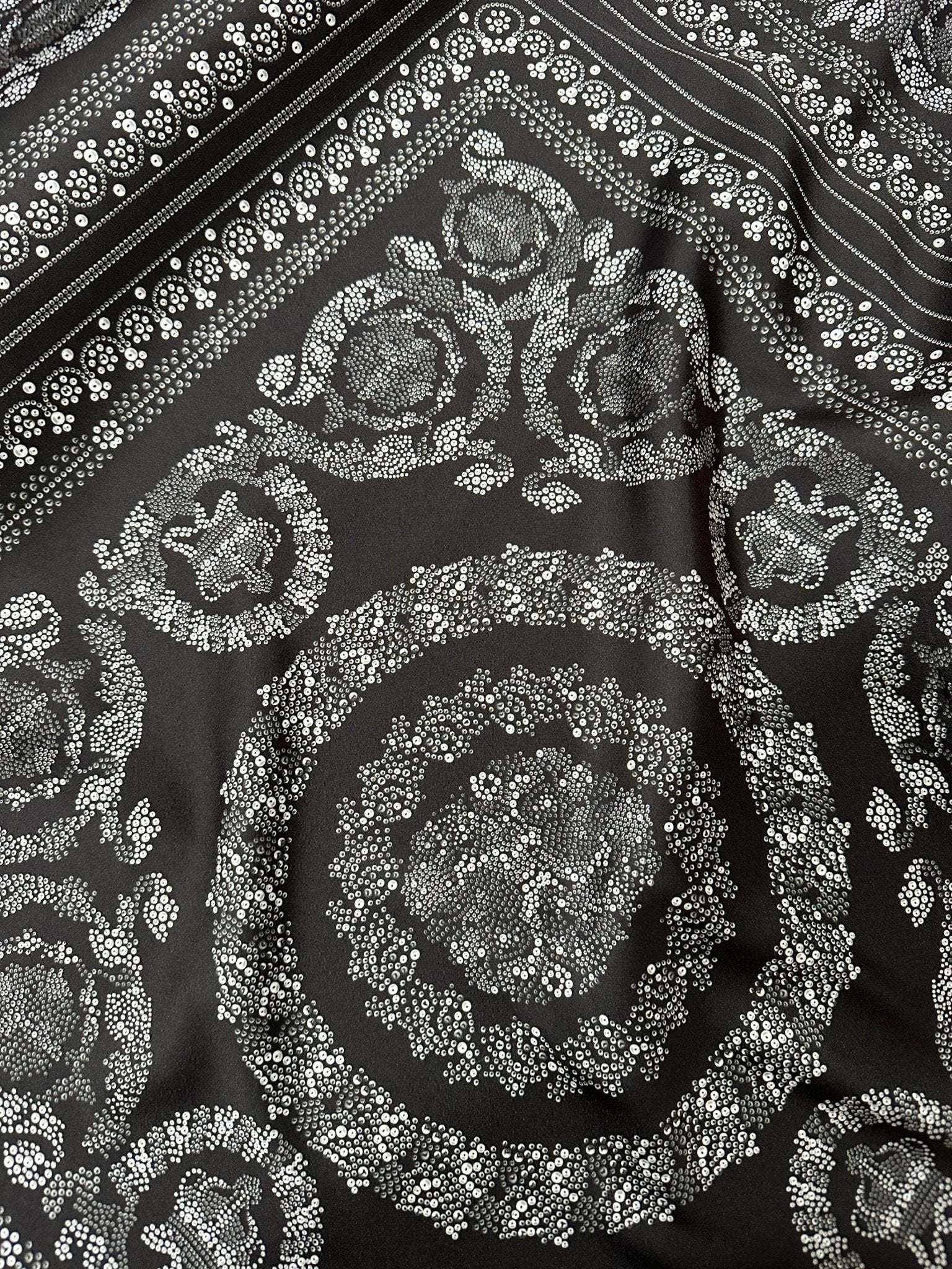 Baroque silver upholstery fabric with intricate floral and circular Baroque pattern on dark background