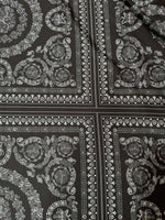 Baroque silver upholstery fabric with intricate floral and ornamental patterns on a dark background, perfect for elegant upholstery projects